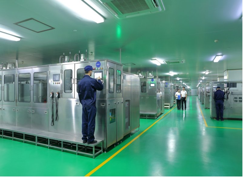Operators running assembly and packing machines in a medical device workshop