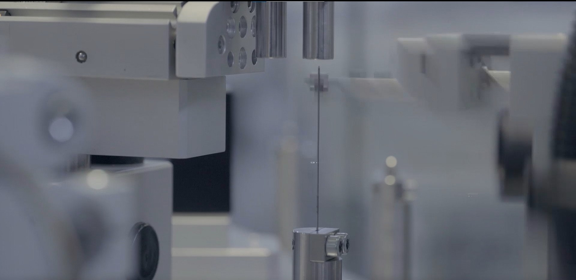 Camera-based vision inspection station checking a medical device component during production