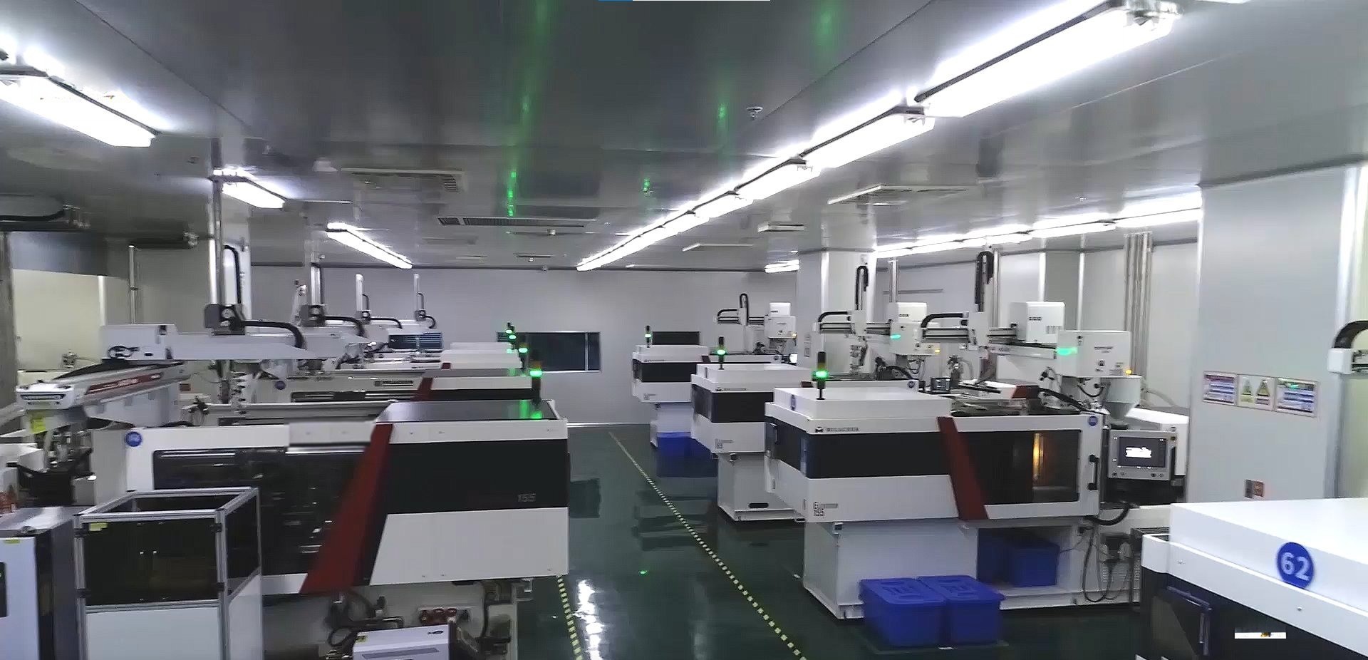 Rows of injection molding machines inside a cleanroom medical device factory workshop